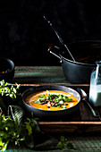 Pumpkin cream soup with koriander, black sesame and coconut milk