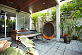 Hanging chair on roofed terrace