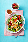 Salad with grilled chicken, strawberries and feta cheese