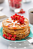 Pancakes with maple syrup and red currants