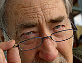 Man peering over the top of his reading glasses
