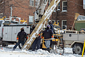 Workers putting up a utility pole