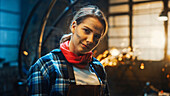 Smiling sculptor in a metal workshop