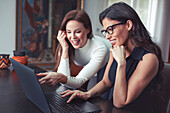 Young women working in home office