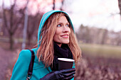 Woman walking with hot drink