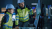 Engineers in factory control room