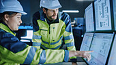 Engineers in factory control room