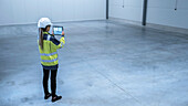 Engineer standing in an empty warehouse