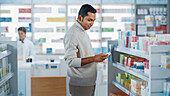 Customer using a smartphone in a pharmacy