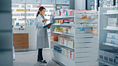 Pharmacist using a digital tablet in a pharmacy