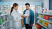 Pharmacist advising a customer on medication