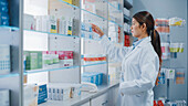 Pharmacist arranging medication on shelves