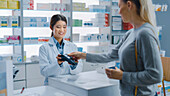 Pharmacist recommending medication at the counter