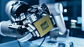 Robotic arm holding a computer processor