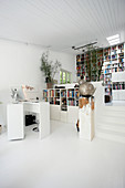 Study and library in open-plan, split-level interior with steps