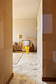 Glance into the living room of the yellow stool and floor lamp