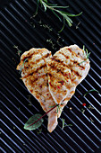 Grilled chicken filet arranged in the shape of a heart