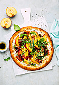 Sommerpizza mit Pfirsich, Parmaschinken und Rucola