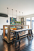 Motorbike in the display case and wooden trestles in white living room