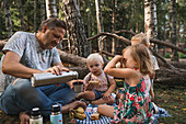 Vater mit Kindern beim Picknick