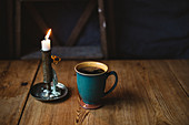 Black coffee and candle on table