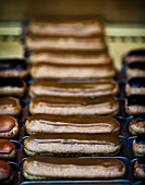 Coffee eclairs in the window of a Paris patisserie