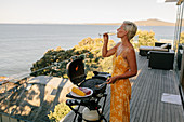 Woman drinking champagne near barbecue