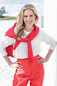 A long-haired blonde woman wearing a red-and-white outfit