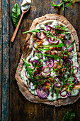 Sourdough crispy flatbreads with sour cream, bacon and red onions