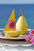 Pear with paper sail and chrysanthemum flower