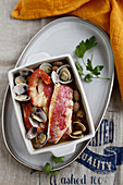 Soup with red mullet, beans, clams and prawns