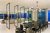 Room divider made of glass between dining area and lounge in a luxury penthouse