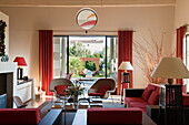 Living room with various seating in converted warehouse, view of terrace