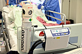 Oxygen canister on hospital bed