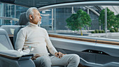 Man sitting in the backseat of an autonomous car