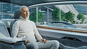 Man sitting in the backseat of an autonomous car