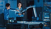 Engineers analysing a robotic arm