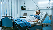 Sick patient lying in a hospital bed