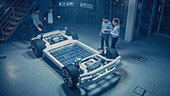 Automotive engineers working on an electric car