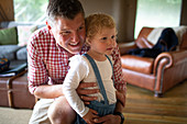 Father hugging daughter in living room