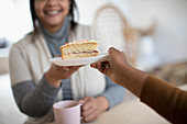 Daughter serving cake to mother