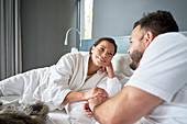 Happy couple relaxing on bed