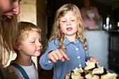 Sisters looking at sweet pastries on plate