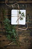 White-wrapped gift for Advent calendar decorated with juniper twigs