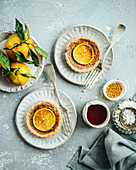 Two orange and frangipane mini tarts with winter citrus, bee pollen, and honey