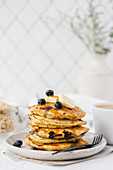 Stack of blueberry pancakes topped with maple syrup