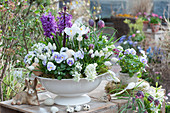 Soup tureen planted with hyacinths, grape hyacinths, horned violets, Ornithogalum, crocus, and checkerboard flower, Easter eggs, and Easter bunny as decoration