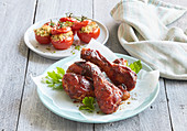 Chicken drumsticks in BBQ sauce with gratinated tomatoes