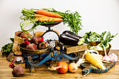 Fresh raw ripe vegetables Healthy food on scales on wooden table background