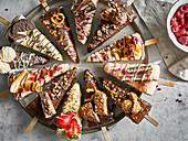 Assorted cheesecake slices on sticks